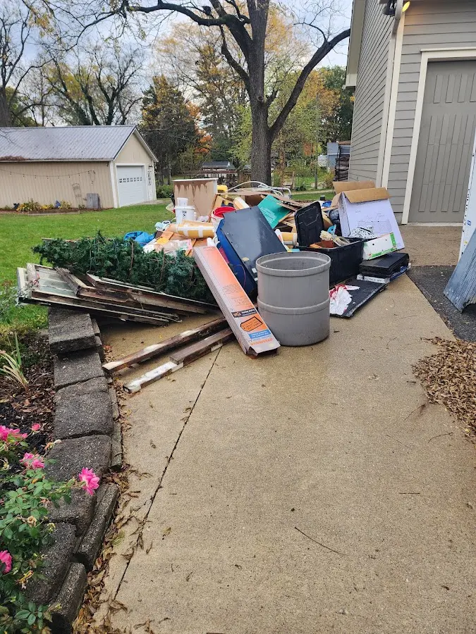 Dumpster being loaded with debris for Estate Cleanout Dumpster Rental in Morgantown